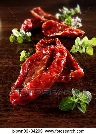 Sun dried tomatoes and oregano View Large Photo Image Stock Image - Sun dried tomatoes and oregano. Fotosearch