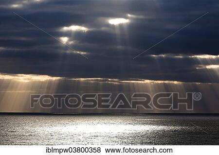 "Sun rays shine through dark storm clouds, Fuerteventura, Canary Islands, Spain, Europe" View Large Photo Image Stock Photo - "Sun rays shine through dark storm clouds, Fuerteventura, Canary Islands, Spain, Europe". Fotosearch