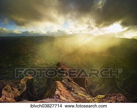 "Sunbeams penetrating the dense rain clouds at Waimea Canyon, Kauai, Hawaii, USA" View Large Photo Image Picture - "Sunbeams penetrating the dense rain clouds at Waimea Canyon, Kauai, Hawaii, USA". Fotosearch