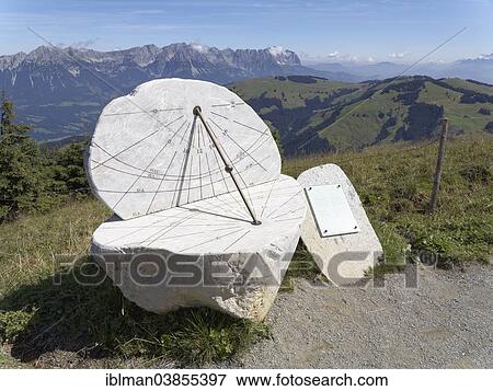 Stock Photo - "Sundial at the panoramic trail around Mt Hohe Salve, Mt Wilder Kaiser at the back, Kitzbuhel Alps, Tyrol, Austria, Europe". Fotosearch