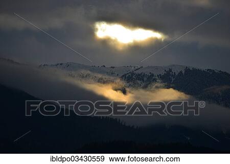 "Sunlight breaking through an overcast sky, near Innsbruck, Tyrol, Austria, Europe" View Large Photo Image Stock Photo - "Sunlight breaking through an overcast sky, near Innsbruck, Tyrol, Austria, Europe". Fotosearch