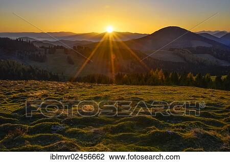 "Sunrays over an alpine pasture at sunset, Sommeralm, Almenland, Styria, Austria, Europe" View Large Photo Image Stock Image - "Sunrays over an alpine pasture at sunset, Sommeralm, Almenland, Styria, Austria, Europe". Fotosearch