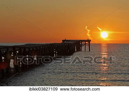 Stock Photo - "Sunrise at a jetty leading out into the sea, Alcudia, Majorca, Balearic Islands, Spain, Europe". Fotosearch