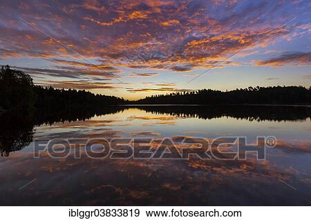 Stock Photo - "Sunrise at a lake, near Ed, Dalsland, Vastra Gotaland, Sweden, Europe". Fotosearch