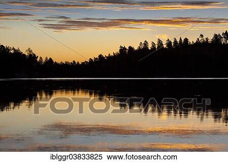 Stock Photography - "Sunrise at a lake, near Ed, Dalsland, Vastra Gotaland, Sweden, Europe". Fotosearch