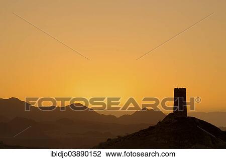 "Sunrise behind the silhouette of a lone decaying watch tower at the edge of the Wahiba Sands desert, Al Mudayrib, Ash Sharqiyah, Oman, Asia" View Large Photo Image Stock Image - "Sunrise behind the silhouette of a lone decaying watch tower at the edge of the Wahiba Sands desert, Al Mudayrib, Ash Sharqiyah, Oman, Asia". Fotosearch