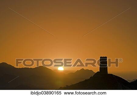 "Sunrise behind the silhouette of a lone decaying watch tower at the edge of the Wahiba Sands desert, Al Mudayrib, Ash Sharqiyah, Oman, Asia" View Large Photo Image Stock Photography - "Sunrise behind the silhouette of a lone decaying watch tower at the edge of the Wahiba Sands desert, Al Mudayrib, Ash Sharqiyah, Oman, Asia". Fotosearch
