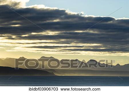 Stock Image - "Sunrise on the coast of the Indian Ocean, mountain ridge, Plettenberg Bay or Plettenbergbaai, Garden Route, Eden District, Western Cape, South Africa, Africa". Fotosearch