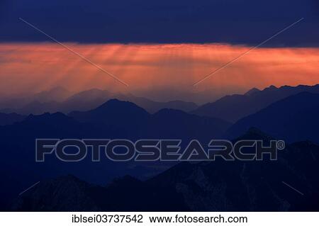 "Sunrise over the Ammer Mountains with a dramatic sky and sun rays, Ammergau Alps, Reutte, Reutte District, Tyrol, Austria, Europe" View Large Photo Image Stock Image - "Sunrise over the Ammer Mountains with a dramatic sky and sun rays, Ammergau Alps, Reutte, Reutte District, Tyrol, Austria, Europe". Fotosearch