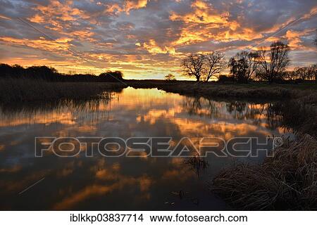 "Sunrise over the Leiner See lake in the Middle Elbe Biosphere Reserve, Dessau, Saxony-Anhalt, Germany, Europe" View Large Photo Image Picture - "Sunrise over the Leiner See lake in the Middle Elbe Biosphere Reserve, Dessau, Saxony-Anhalt, Germany, Europe". Fotosearch