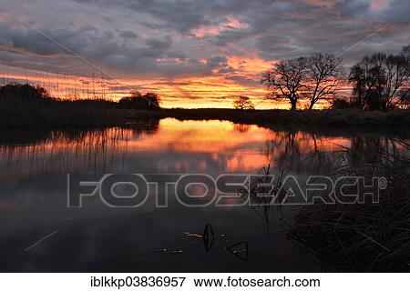 "Sunrise over the Leiner See lake in the Middle Elbe Biosphere Reserve, Dessau, Saxony-Anhalt, Germany, Europe" View Large Photo Image Stock Photo - "Sunrise over the Leiner See lake in the Middle Elbe Biosphere Reserve, Dessau, Saxony-Anhalt, Germany, Europe". Fotosearch