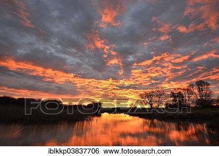 Stock Photograph - "Sunrise over the Leiner See lake in the Middle Elbe Biosphere Reserve, Dessau, Saxony-Anhalt, Germany, Europe". Fotosearch