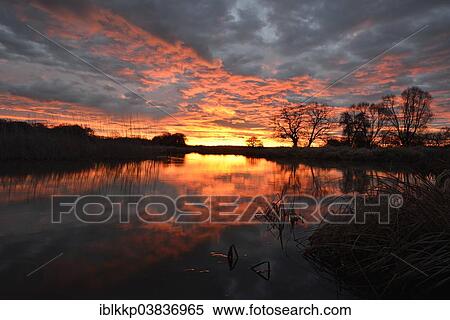 "Sunrise over the Leiner See lake in the Middle Elbe Biosphere Reserve, Dessau, Saxony-Anhalt, Germany, Europe" View Large Photo Image Stock Photography - "Sunrise over the Leiner See lake in the Middle Elbe Biosphere Reserve, Dessau, Saxony-Anhalt, Germany, Europe". Fotosearch