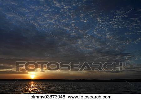 Stock Photo - "Sunrise over the Woterfitzsee lake, Mecklenburgische Seenplatte, Mecklenburg-Western Pomerania, Germany, Europe". Fotosearch