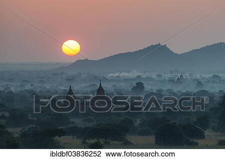 "Sunrise, temples in the morning mist, stupas and pagodas in the temple complex of the Plateau of Bagan, Mandalay Division, Myanmar or Burma" View Large Photo Image Stock Image - "Sunrise, temples in the morning mist, stupas and pagodas in the temple complex of the Plateau of Bagan, Mandalay Division, Myanmar or Burma". Fotosearch