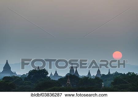 "Sunrise, temples in the morning mist, stupas and pagodas in the temple complex of the Plateau of Bagan, Mandalay Division, Myanmar or Burma" View Large Photo Image Stock Photo - "Sunrise, temples in the morning mist, stupas and pagodas in the temple complex of the Plateau of Bagan, Mandalay Division, Myanmar or Burma". Fotosearch