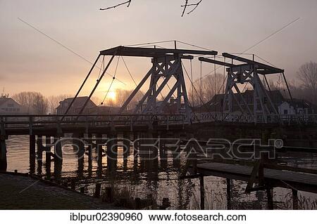 "Sunrise with mist at Wiecker Bridge and harbour, Wieck district, Greifswald, Mecklenburg-Western Pomerania, Germany, Europe" View Large Photo Image Stock Image - "Sunrise with mist at Wiecker Bridge and harbour, Wieck district, Greifswald, Mecklenburg-Western Pomerania, Germany, Europe". Fotosearch