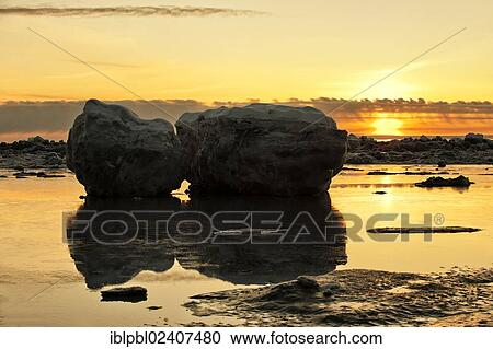 Stock Image - "Sunset and stranded icebergs at low tide in Turnagain Arm, Alaska". Fotosearch