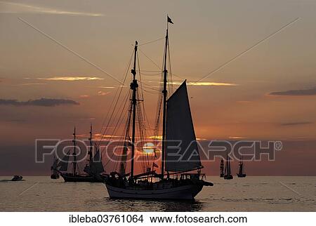 "Sunset at the Hanse Sail 2013, Baltic Sea near the entrance to the port, Warnemunde, Rostock, Mecklenburg-Western Pomerania, Germany, Europe" View Large Photo Image Picture - "Sunset at the Hanse Sail 2013, Baltic Sea near the entrance to the port, Warnemunde, Rostock, Mecklenburg-Western Pomerania, Germany, Europe". Fotosearch