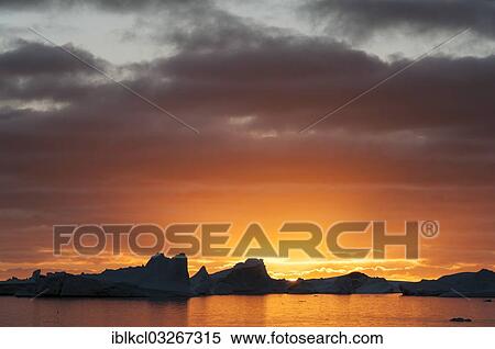 "Sunset behind icebergs, Booth Island, Pleneau Bay, Antarctic Peninsula, Antarctica" View Large Photo Image Stock Photography - "Sunset behind icebergs, Booth Island, Pleneau Bay, Antarctic Peninsula, Antarctica". Fotosearch