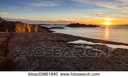 Stock Image - "Sunset on the coast, near Henningsvaer, Austvagoy or Austvagoya, Lofoten, Norway, Europe". Fotosearch