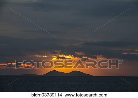 Picture - "Sunset on the west coast of Flores Island, Komodo, Nusa Tenggara Timur, Indonesia, Asia". Fotosearch