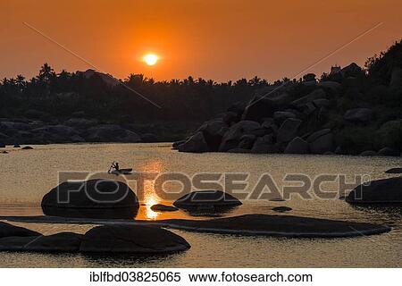 "Sunset over Tungabhadra river and a part of the ruins of the former Vijayanagara Empire, Hampi, Karnataka, India, Asia" View Large Photo Image Stock Photography - "Sunset over Tungabhadra river and a part of the ruins of the former Vijayanagara Empire, Hampi, Karnataka, India, Asia". Fotosearch