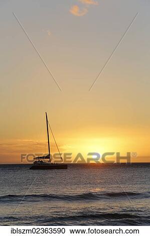 Stock Image - "Sunset, sailboat, Kaanapali, Maui, Hawaii, USA, America". Fotosearch