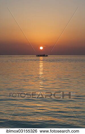 Stock Photograph - "Sunset with a Dohni, a Maldivian fishing boat, Indian Ocean, Male, North Male Atoll, Maldives, Asia". Fotosearch