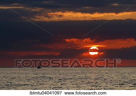 "Sunset with a sailing boat on the Baltic Sea, Gellen, Plogshagen, Hiddensee, Mecklenburg-Western Pomerania, Germany, Europe" View Large Photo Image Stock Photo - "Sunset with a sailing boat on the Baltic Sea, Gellen, Plogshagen, Hiddensee, Mecklenburg-Western Pomerania, Germany, Europe". Fotosearch