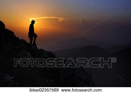 Stock Photo - "Sunset with a silhouette of a mountain climber, Geisshorn Mountain, Tannheim Valley, Tyrol, Austria, Europe". Fotosearch