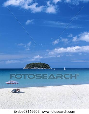 Stock Image - "Sunshades and beach chairs, Kata Beach, the island of Ko Pu at the back, Andaman Sea, Phuket, Phuket Province, Thailand, Asia". Fotosearch