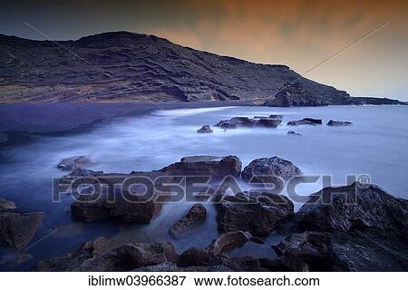 "Surf at the lava beach, evening light, Charco de los Clicos in El Golfo, Lanzarote, Canary Islands, Spain, Europe" View Large Photo Image Stock Photo - "Surf at the lava beach, evening light, Charco de los Clicos in El Golfo, Lanzarote, Canary Islands, Spain, Europe". Fotosearch