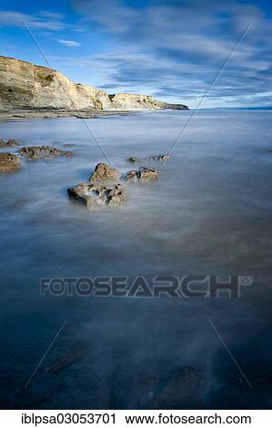 Stock Image - "Surf with cliffs, Dunraven Bay, Glamorgan Heritage Coast, Wales, United Kingdom, Europe". Fotosearch