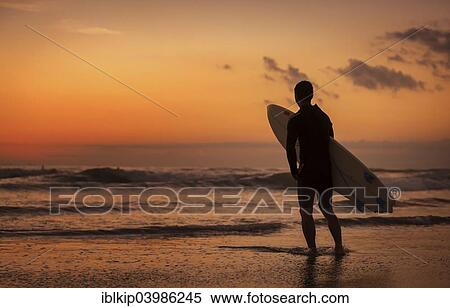 Stock Photography - "Surfer at sunset, Sanur Beach, Bali, Indonesia, Asia". Fotosearch