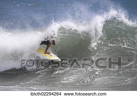 Picture - "Surfer at the exit of a tube, North Shore, Tahiti, French Polynesia, Polynesia, South Pacific, Oceania". Fotosearch