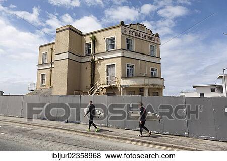 "Surfers walking in front of the abandoned Fistral Bay Hotel, Newquay, Cornwall, England, Great Britain, Europe" View Large Photo Image Stock Photo - "Surfers walking in front of the abandoned Fistral Bay Hotel, Newquay, Cornwall, England, Great Britain, Europe". Fotosearch