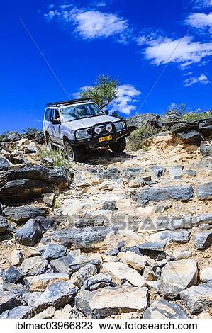 "SUV driving down rock steps, Tsauchab, Namibia, Africa" View Large Photo Image Stock Image - "SUV driving down rock steps, Tsauchab, Namibia, Africa". Fotosearch