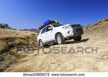 "SUV driving through the mud of the Huab River, Damaraland, Namibia, Africa" View Large Photo Image Stock Image - "SUV driving through the mud of the Huab River, Damaraland, Namibia, Africa". Fotosearch