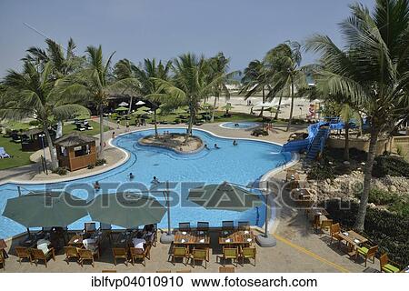 "Swimming pool of the Hilton Hotel, Salalah, Dhofar Region, Orient, Oman, Asia" View Large Photo Image Stock Image - "Swimming pool of the Hilton Hotel, Salalah, Dhofar Region, Orient, Oman, Asia". Fotosearch