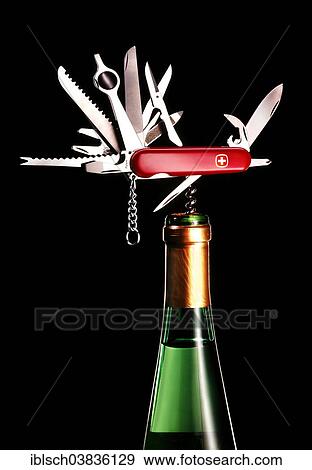 "Swiss Army knife, with all parts unfolded, corkscrew in a white wine bottle" View Large Photo Image Stock Photo - "Swiss Army knife, with all parts unfolded, corkscrew in a white wine bottle". Fotosearch