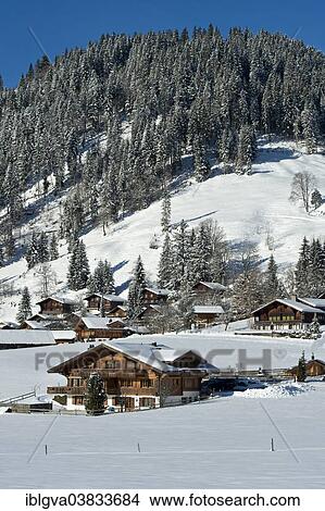 Picture - "Swiss chalets in a winter landscape in Saanenland, Schonried, Canton of Bern, Switzerland, Europe". Fotosearch