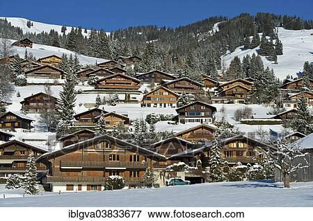 Stock Photo - "Swiss chalets in a winter landscape in Saanenland, Schonried, Canton of Bern, Switzerland, Europe". Fotosearch