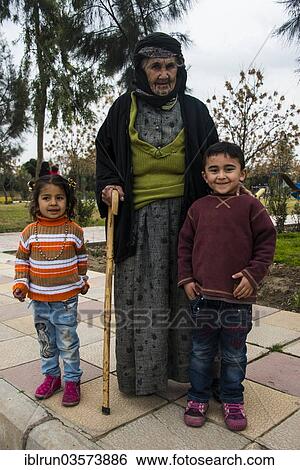 "Syrian Orthodox Kurdish woman with tattoos on her face and her grandchildren, Erbil, Arbil Province, Iraqi Kurdistan, Iraq, Asia" View Large Photo Image Stock Photograph - "Syrian Orthodox Kurdish woman with tattoos on her face and her grandchildren, Erbil, Arbil Province, Iraqi Kurdistan, Iraq, Asia". Fotosearch