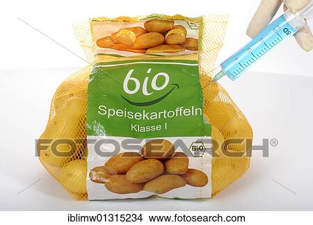 "Syringe sticking in potatoes with BIO marking on the label, symbolic image, fraud with food labelled """"organic""""" View Large Photo Image Picture - "Syringe sticking in potatoes with BIO marking on the label, symbolic image, fraud with food labelled """"organic""""". Fotosearch