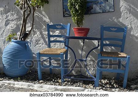 "Table and chairs on a terrace, Kos town, Kos, Greece, Europe" View Large Photo Image Stock Image - "Table and chairs on a terrace, Kos town, Kos, Greece, Europe". Fotosearch