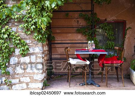 Stock Photo - "Table and chairs outside a house, Roussillon, Vaucluse, Provence, France, Europe". Fotosearch