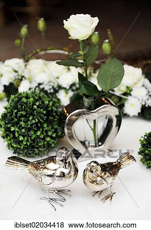 "Table decoration for a wedding table, white rose in heart-shaped vase, with two birds at the front" View Large Photo Image Stock Photo - "Table decoration for a wedding table, white rose in heart-shaped vase, with two birds at the front". Fotosearch