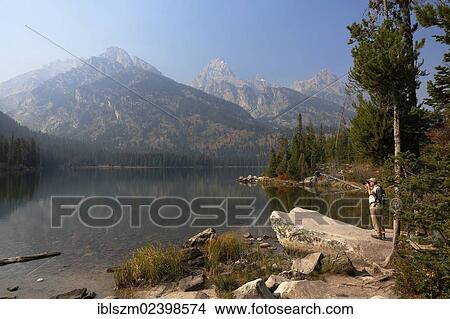 "Taggart Lake with a photographer, Grand Teton National Park, Wyoming, USA" View Large Photo Image Picture - "Taggart Lake with a photographer, Grand Teton National Park, Wyoming, USA". Fotosearch