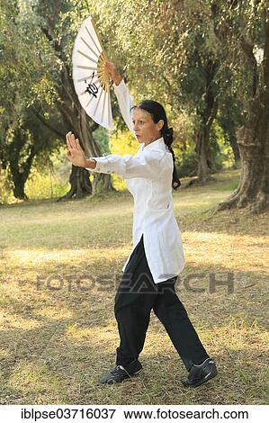 "Tai Chi performed with a fan, demonstration in an olive grove, Regine Zanini, two-time silver medalist of the Tai Chi European Championships 2012, Menton, French Riviera, Alpes-Maritimes, Provence-Alpes-Cote d’Azur, France, Europe" View Large Photo Image Stock Photo - "Tai Chi performed with a fan, demonstration in an olive grove, Regine Zanini, two-time silver medalist of the Tai Chi European Championships 2012, Menton, French Riviera, Alpes-Maritimes, Provence-Alpes-Cote d’Azur, France, Europe". Fotosearch